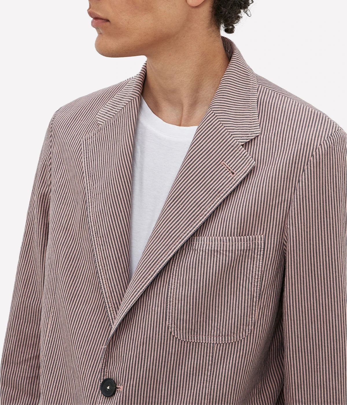 Deconstructed cotton-linen jacket with a two-button front, patch pockets, and dark horn buttons.