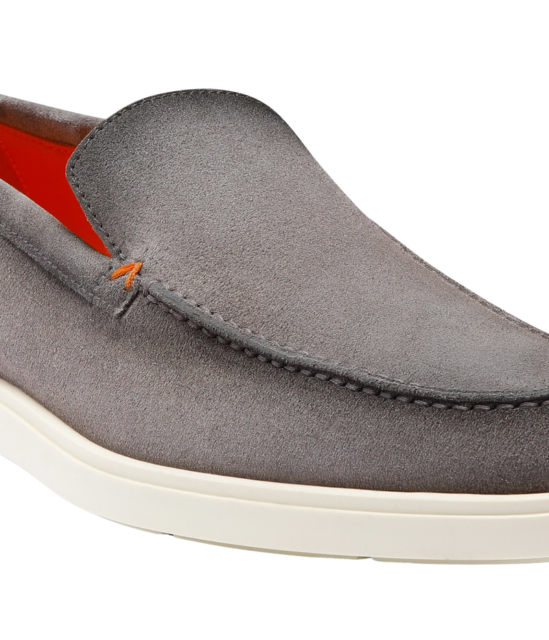 Men's grey suede Santoni loafers with apron stitching, orange detailing, and a smooth rubber sole—crafted in Italy for understated elegance.