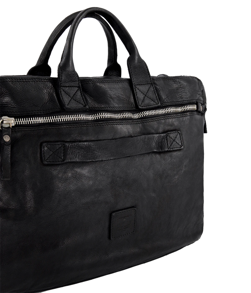 The Campomaggi Leather Briefcase in black is crafted from full-grain Italian leather with a rich, hand-dyed finish. Featuring sturdy top handles, a detachable shoulder strap, and a spacious interior, it’s a timeless blend of function and craftsmanship, perfect for work or travel.