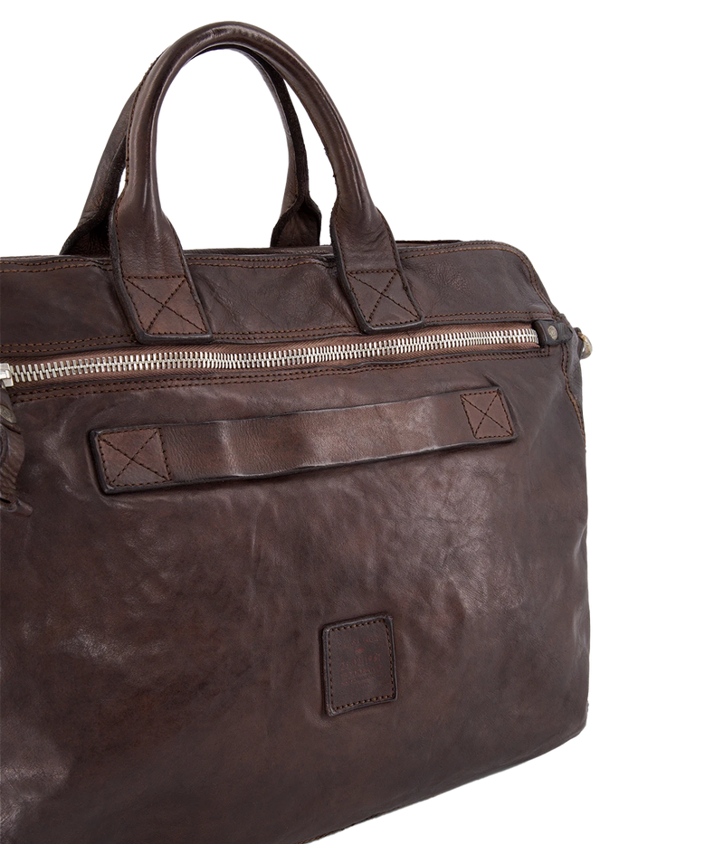 The Campomaggi Leather Briefcase in brown showcases full-grain Italian leather with a vintage-inspired, hand-dyed patina. Designed with top handles, a detachable shoulder strap, and ample storage, it’s a refined yet rugged essential for the modern professional.