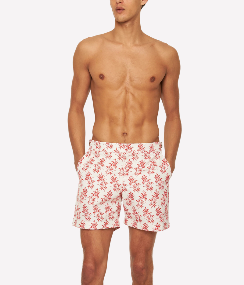 Bulldog Bamboo swim shorts by Orlebar Brown in Summer Red bamboo print on White Sand, made from quick-drying recycled polyester. Features signature Bulldog fit, adjustable branded nickel-effect side fasteners, and concealed snap closure.