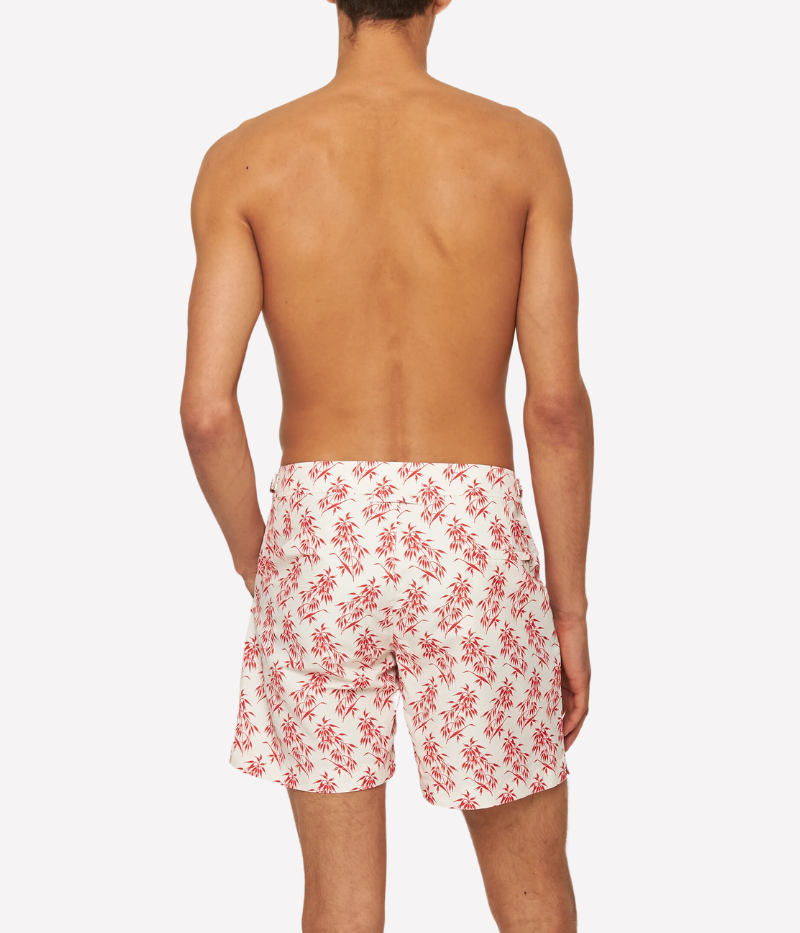 Bulldog Bamboo swim shorts by Orlebar Brown in Summer Red bamboo print on White Sand, made from quick-drying recycled polyester. Features signature Bulldog fit, adjustable branded nickel-effect side fasteners, and concealed snap closure.