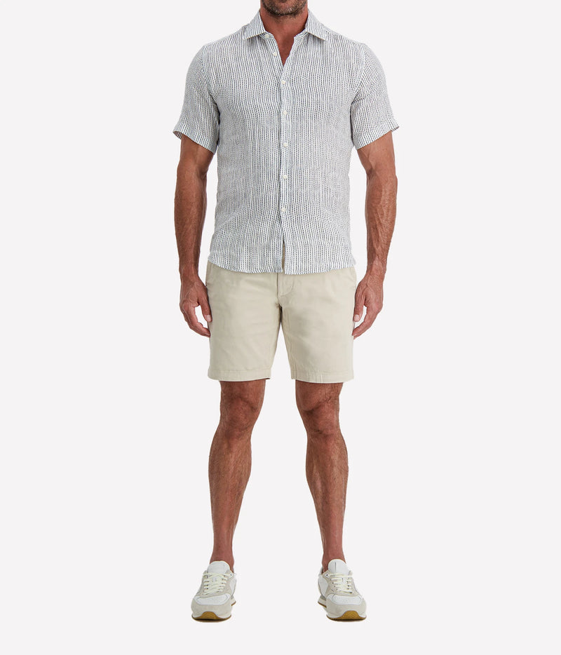 Man wearing Osvaldo Trucchi Linen Short Sleeve Shirt in Navy Woven Stripe with stone shorts and white sneakers, full-length front view