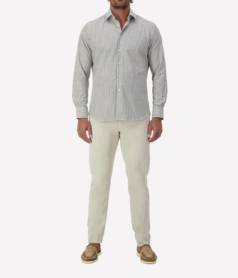 Man wearing Ingram Slim Fit Shirt in Sage & White Stripe with stone chinos and brown suede shoes, full-length front view
