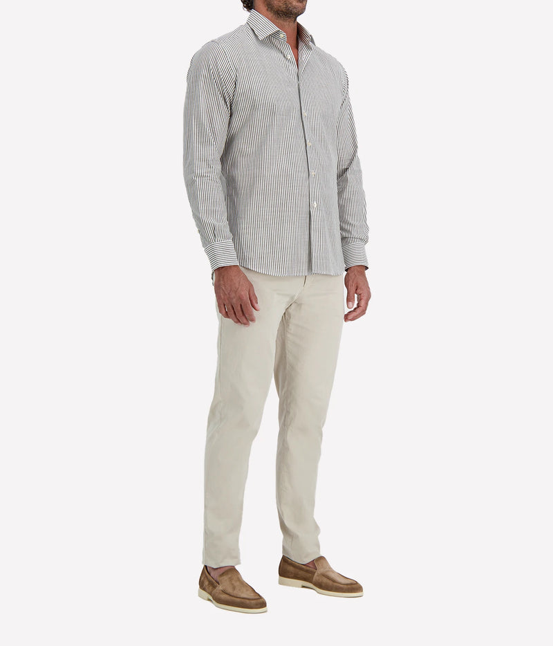 Man wearing Ingram Slim Fit Shirt in Sage & White Stripe with stone chinos and brown suede shoes, angled front view