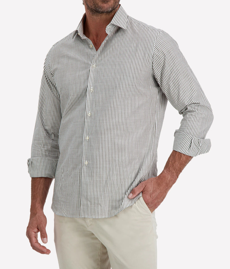 Man wearing Ingram Slim Fit Shirt in Sage & White Stripe with stone chinos, cropped angled front view with hand in pocket