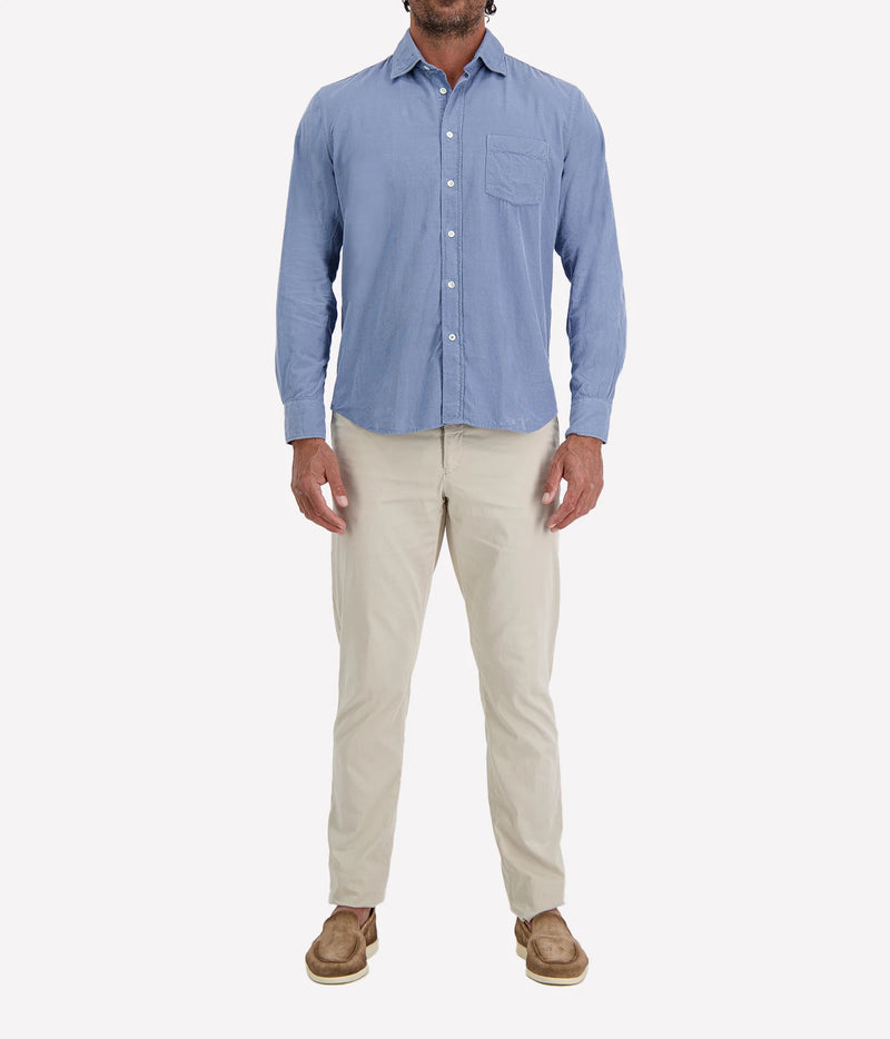 Man wearing Hartford Paul Fine Corduroy Shirt in Chambray Blue with stone chinos and brown suede shoes, full-length front view