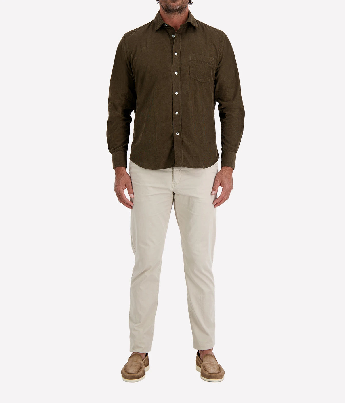 Man wearing Hartford Paul Fine Corduroy Shirt in Olive with stone chinos and brown suede shoes, full-length front view
