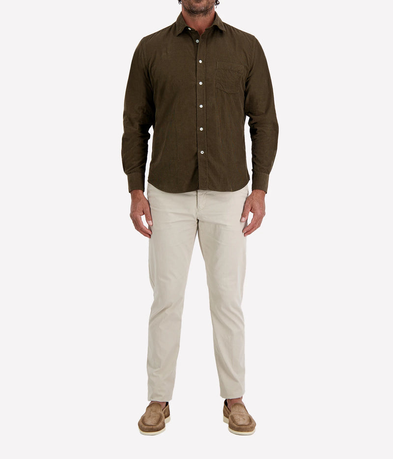 Man wearing Hartford Paul Fine Corduroy Shirt in Olive with stone chinos and brown suede shoes, full-length front view