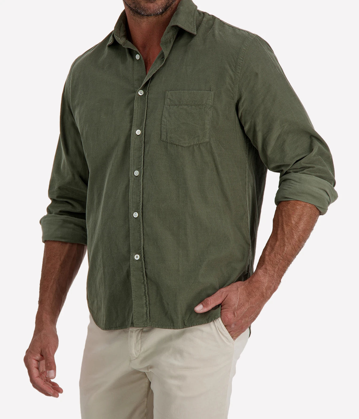Man wearing Hartford Paul Fine Corduroy Shirt in Military with stone chinos, cropped angled front view with hand in pocket