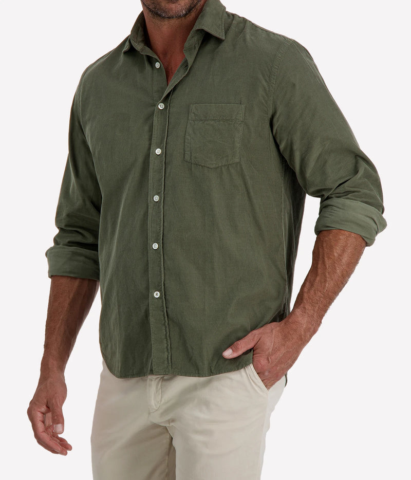 Man wearing Hartford Paul Fine Corduroy Shirt in Military with stone chinos, cropped angled front view with hand in pocket