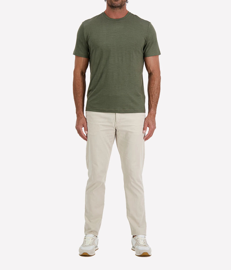 Man wearing Maurizio Baldassari Linate Short Sleeve T-Shirt in Dark Olive with stone trousers and white sneakers, full-length front view