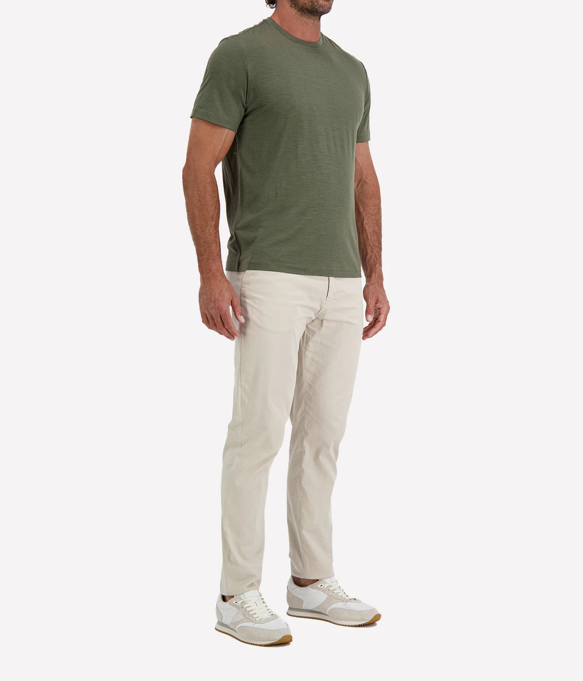 Man wearing Maurizio Baldassari Linate Short Sleeve T-Shirt in Dark Olive with stone trousers and white sneakers, three-quarter view
