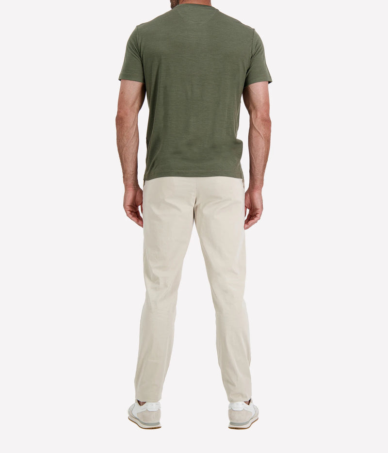 Back view of man wearing Maurizio Baldassari Linate Short Sleeve T-Shirt in Dark Olive with stone trousers and white sneakers