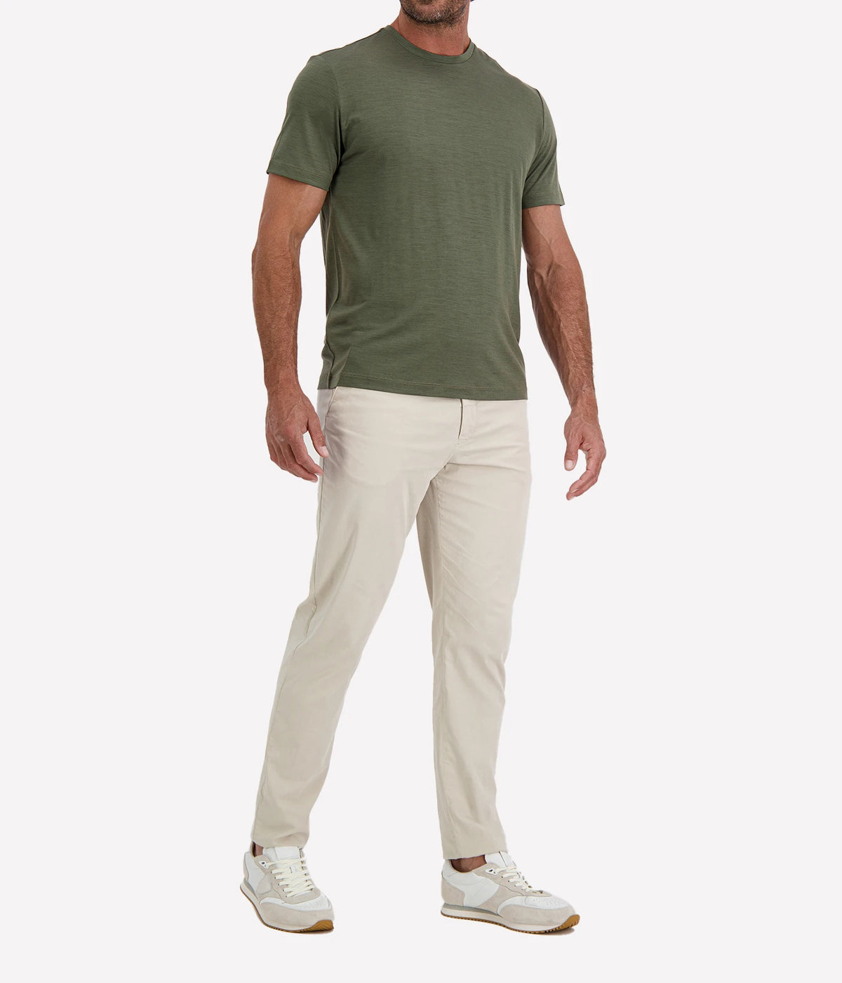 Man wearing Maurizio Baldassari Linate Short Sleeve T-Shirt in Dark Olive with stone trousers and white sneakers, angled front view