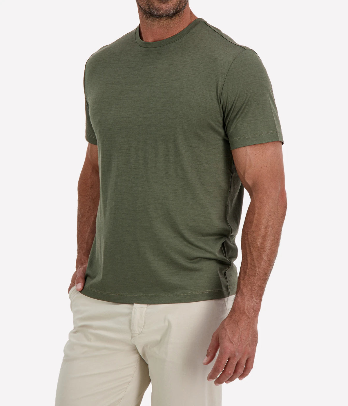 Man wearing Maurizio Baldassari Linate Short Sleeve T-Shirt in Dark Olive with stone trousers, cropped angled front view with hand in pocket