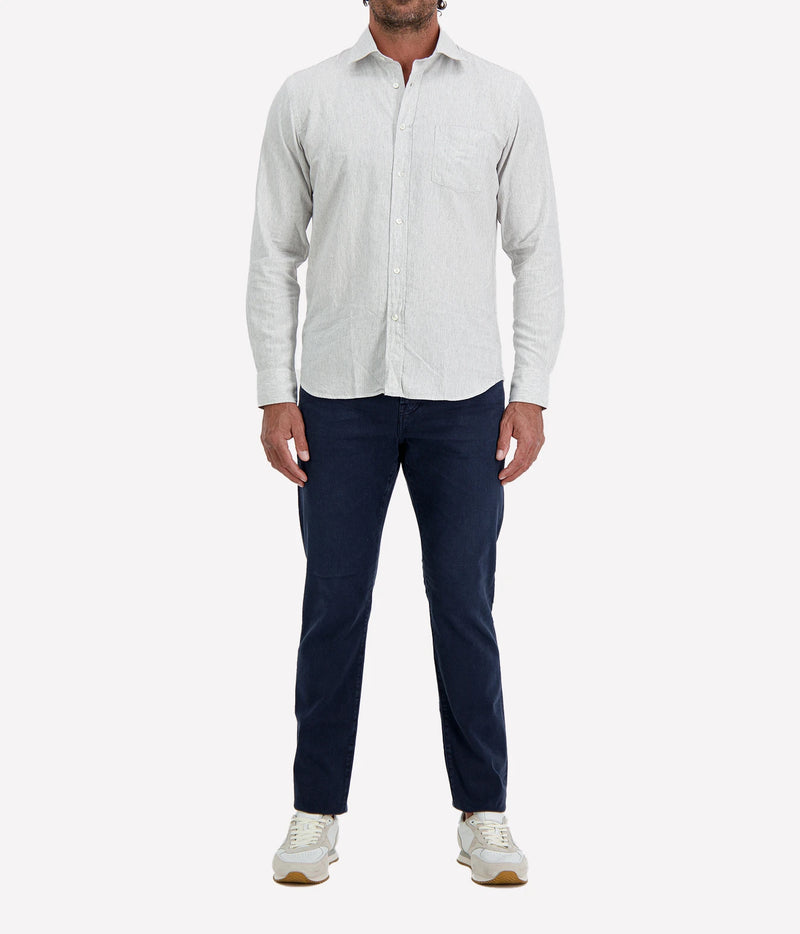 Man wearing Hartford Paul Cotton Shirt in Grey with indigo jeans and white sneakers, full-length front view