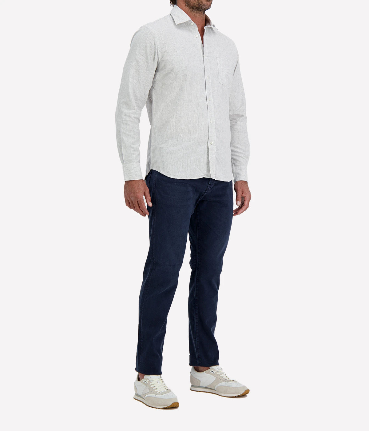 Man wearing Hartford Paul Cotton Shirt in Grey with indigo jeans and white sneakers, three-quarter view