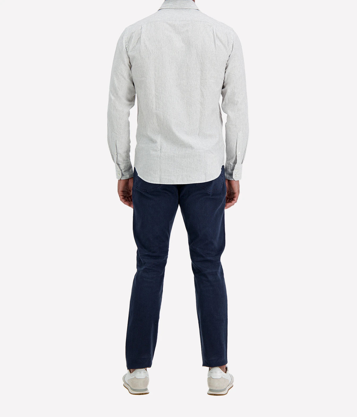 Back view of man wearing Hartford Paul Cotton Shirt in Grey with indigo jeans and white sneakers