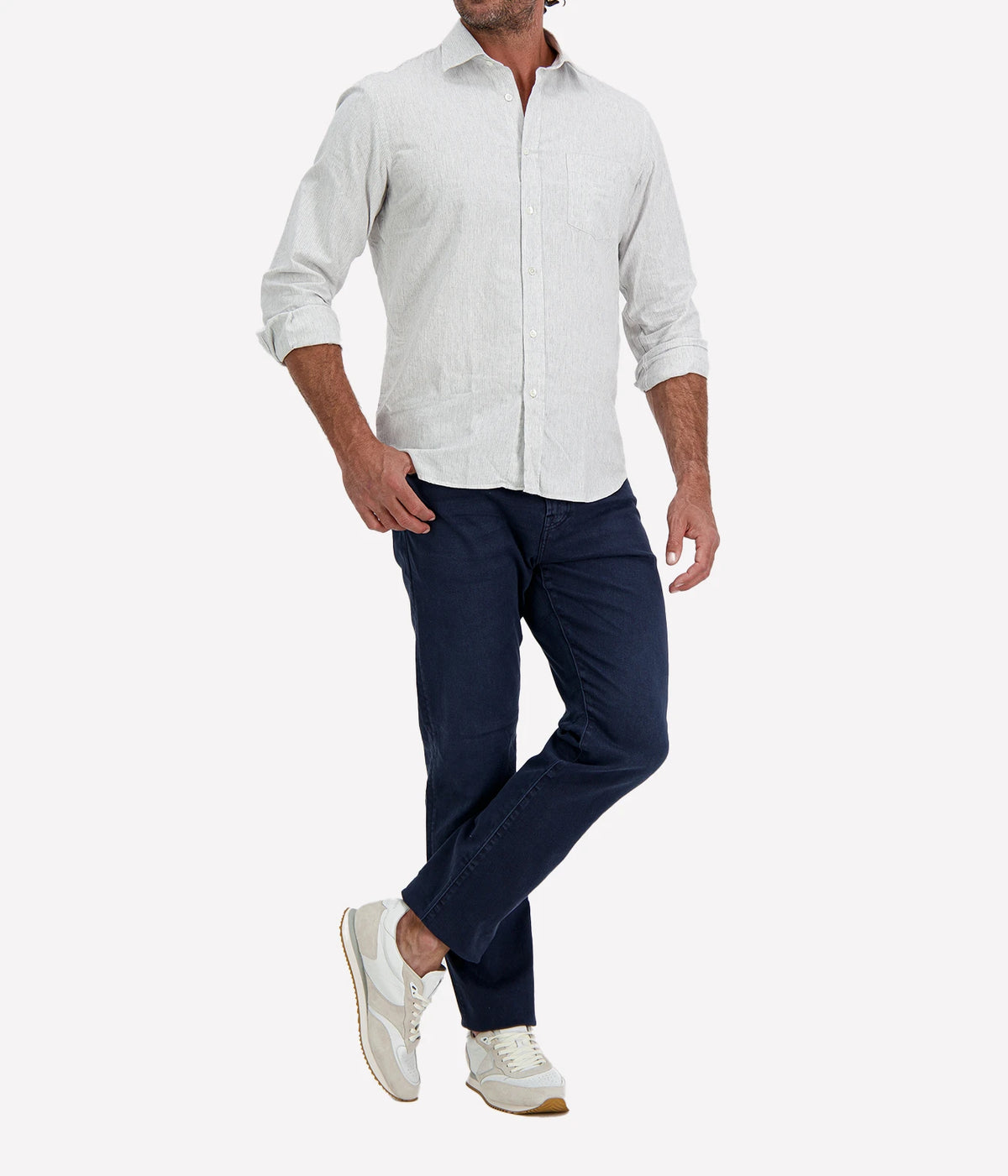 Man wearing Hartford Paul Cotton Shirt in Grey with indigo jeans and white sneakers, angled front view with hand in pocket