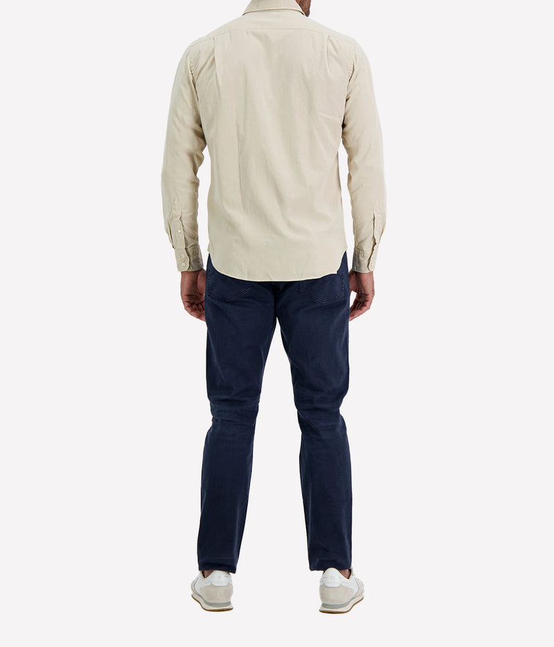 Back view of man wearing Hartford Paul Tencel & Cotton Shirt in Stone with indigo jeans and white sneakers