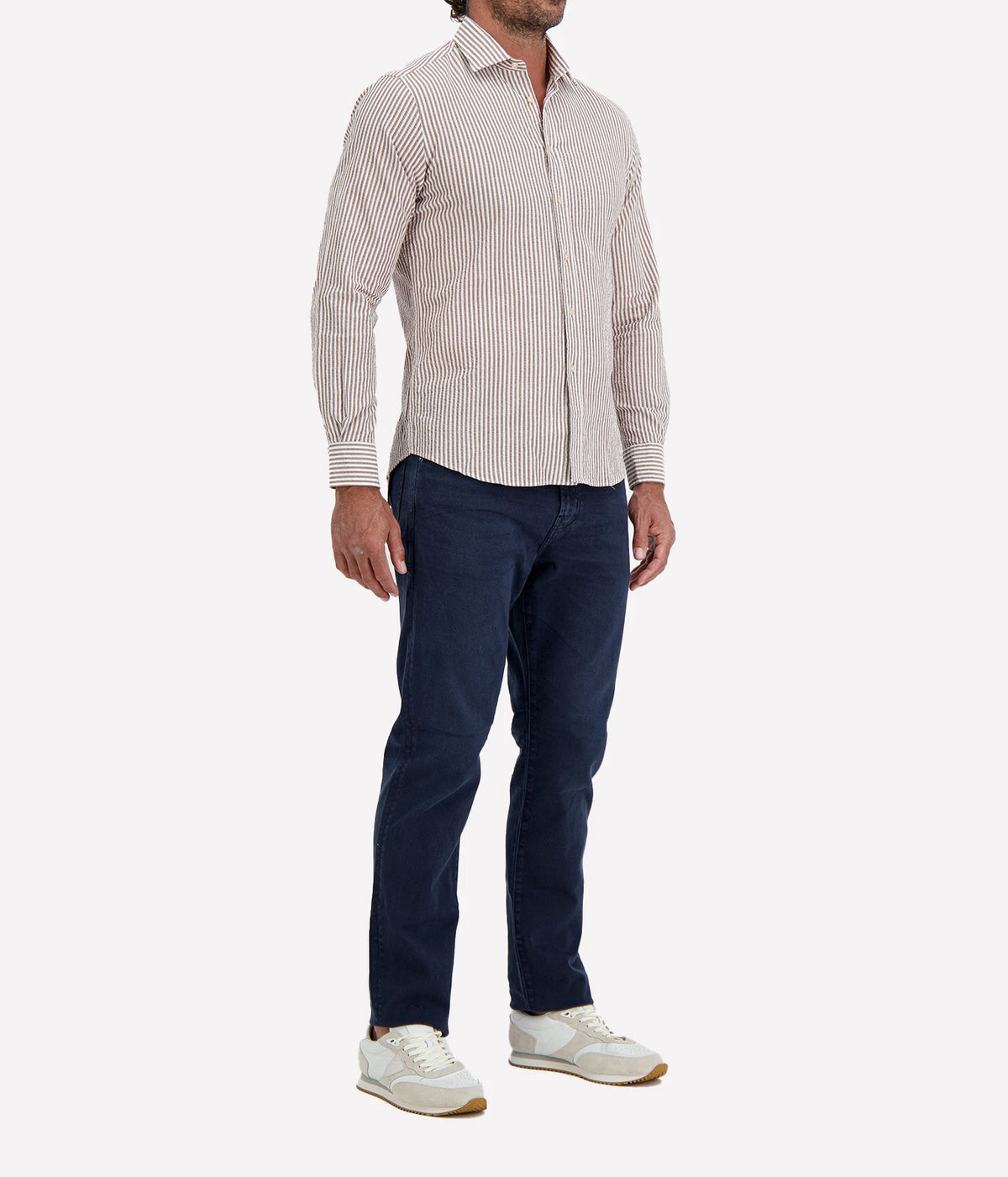 Man wearing Ingram Slim Fit Shirt in Seersucker Brown & White Stripe with indigo jeans and white sneakers, three-quarter view
