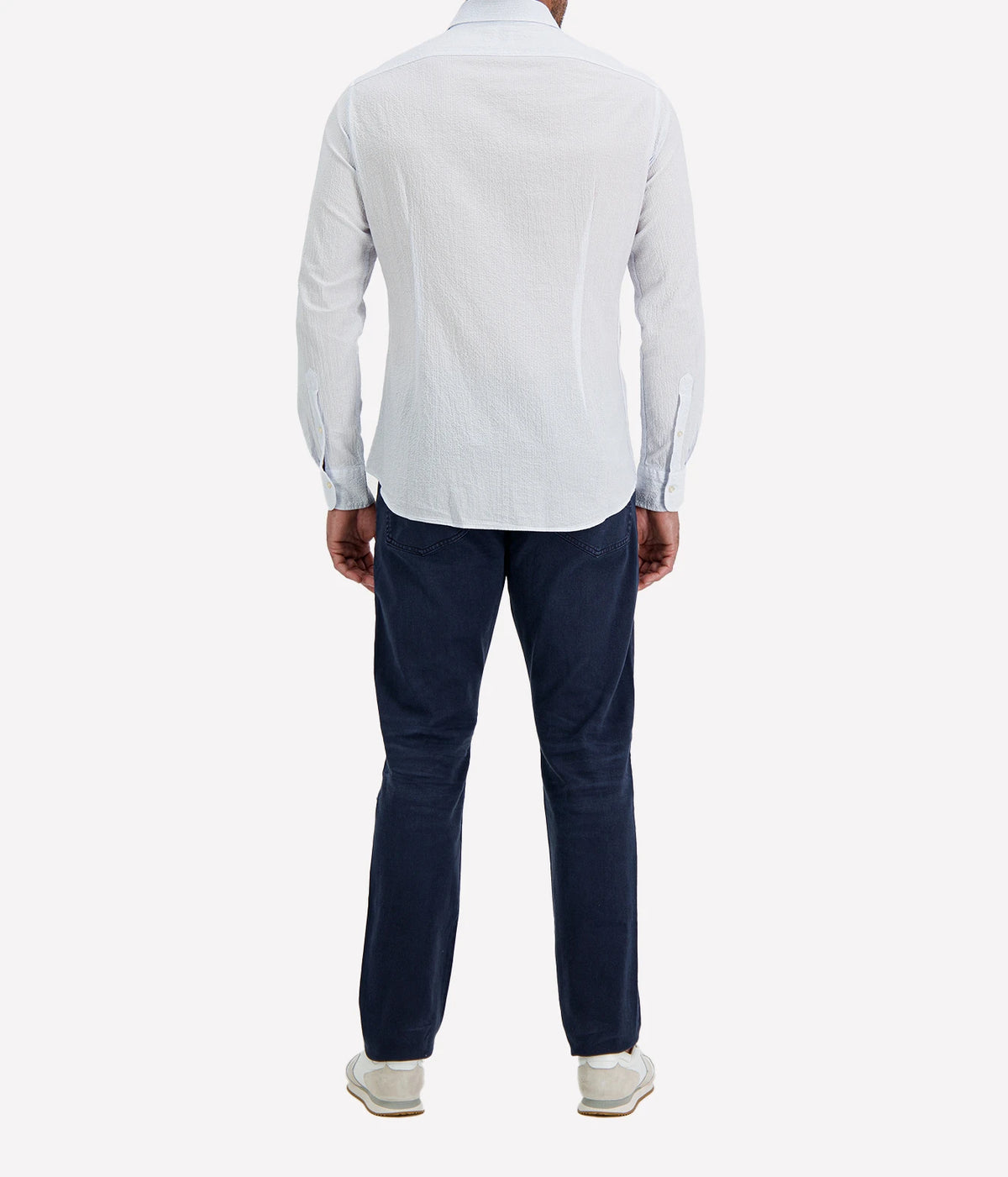 Back view of man wearing Ingram Slim Fit Shirt in Seersucker Blue & White Stripe with indigo jeans and white sneakers