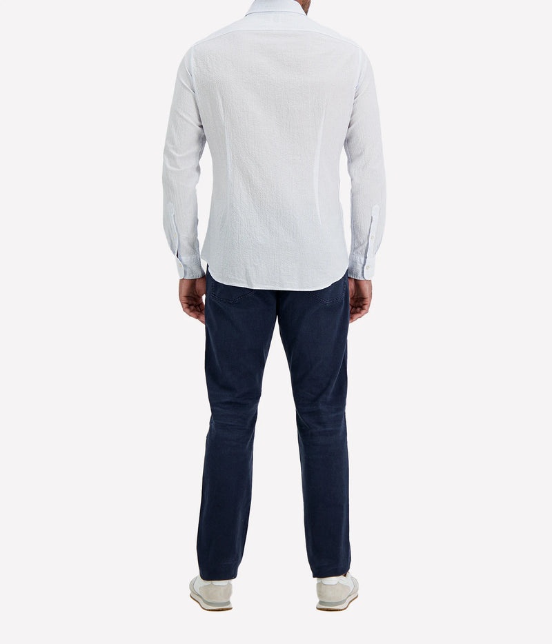 Back view of man wearing Ingram Slim Fit Shirt in Seersucker Blue & White Stripe with indigo jeans and white sneakers