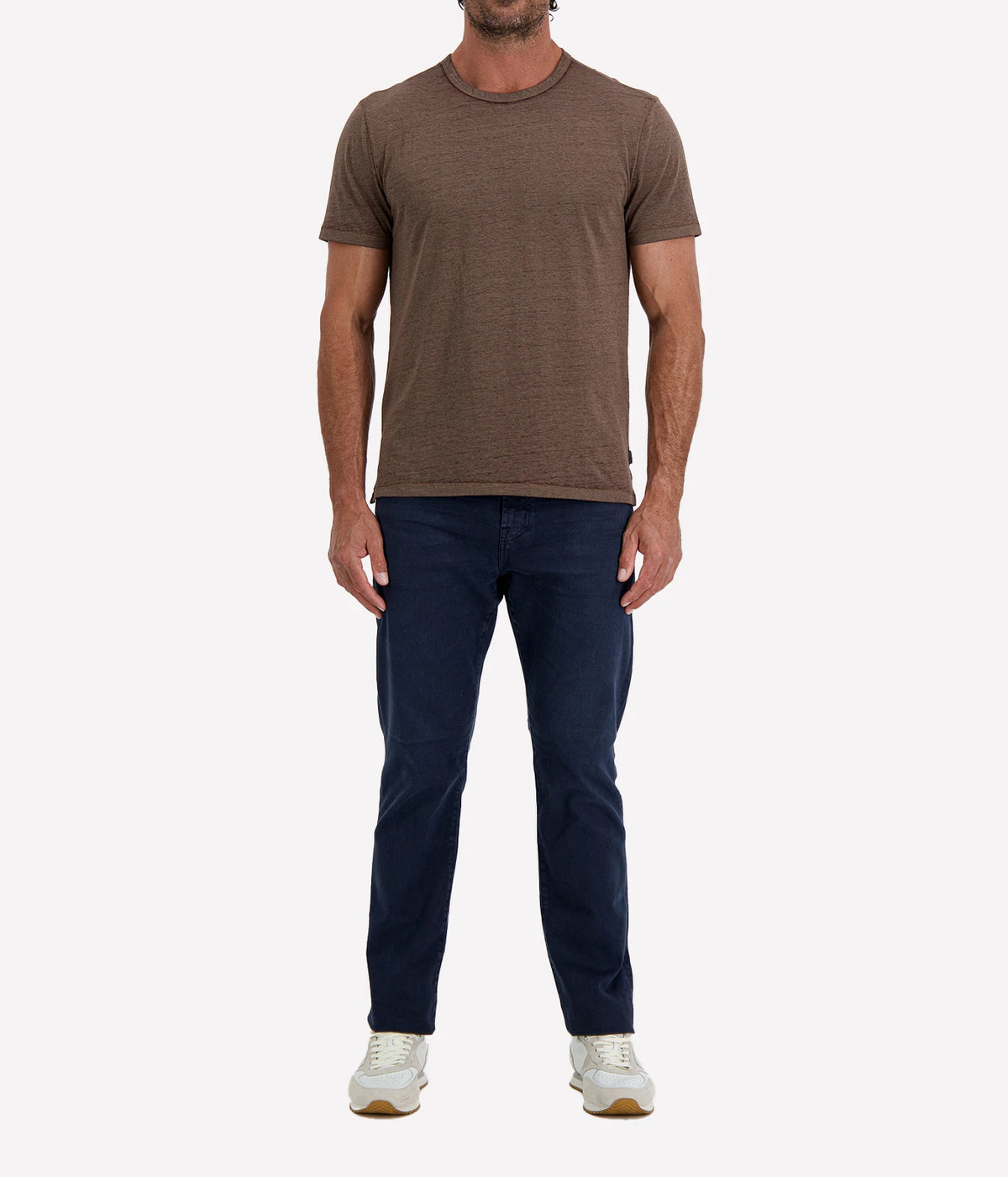 Man wearing John Varvatos Bale Burnout Crewneck Tee in Teakwood with indigo jeans and white sneakers, full-length front view