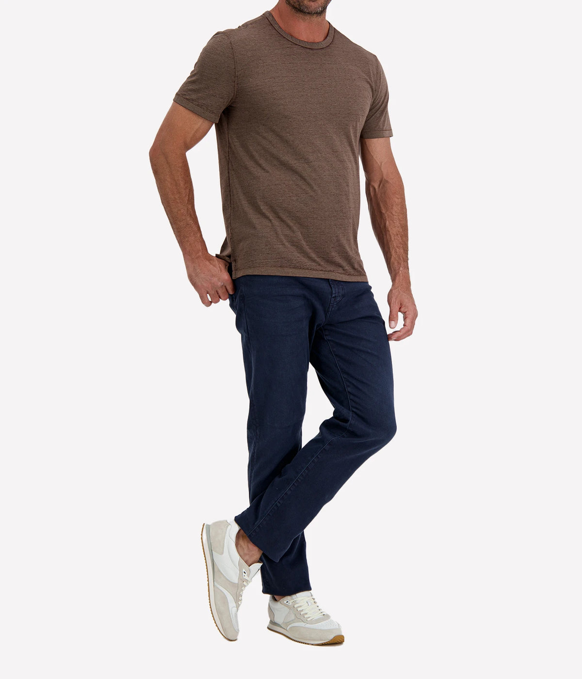 Man wearing John Varvatos Bale Burnout Crewneck Tee in Teakwood with indigo jeans and white sneakers, three-quarter view