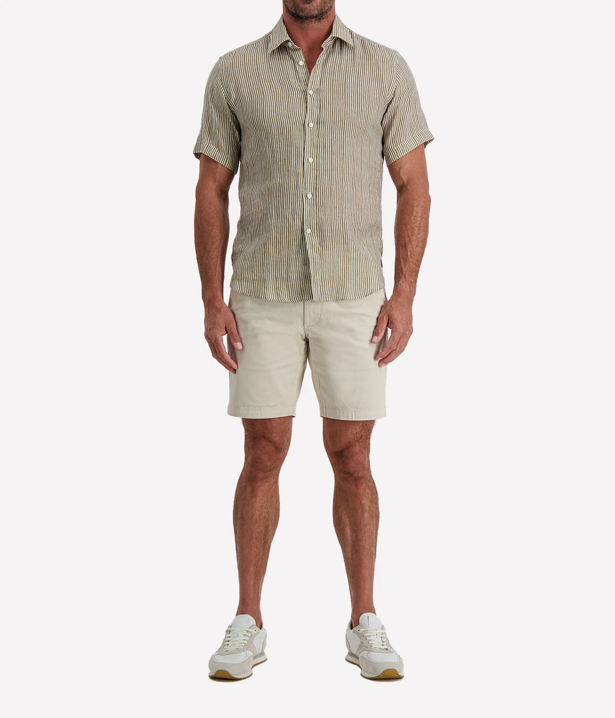 Man wearing Osvaldo Trucchi Linen Short Sleeve Shirt in Olive and White Stripe with stone shorts and white sneakers, full-length front view