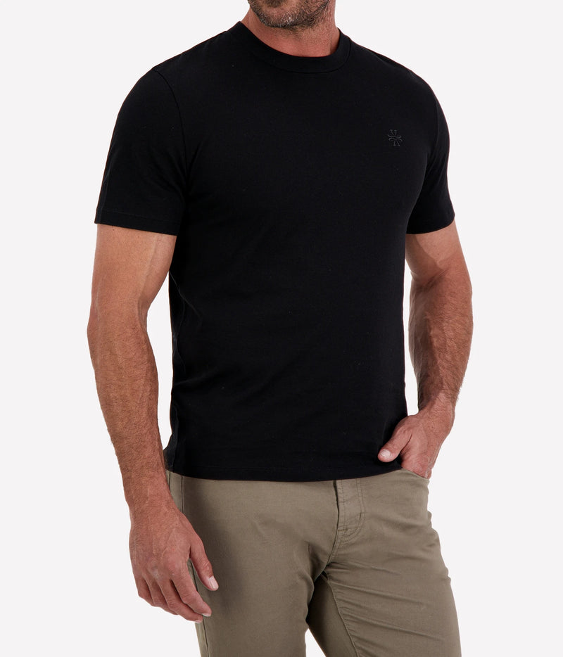 Man wearing Jacob Cohën Girocollo Costina T-Shirt in Black with khaki chinos, cropped front view with hand in pocket