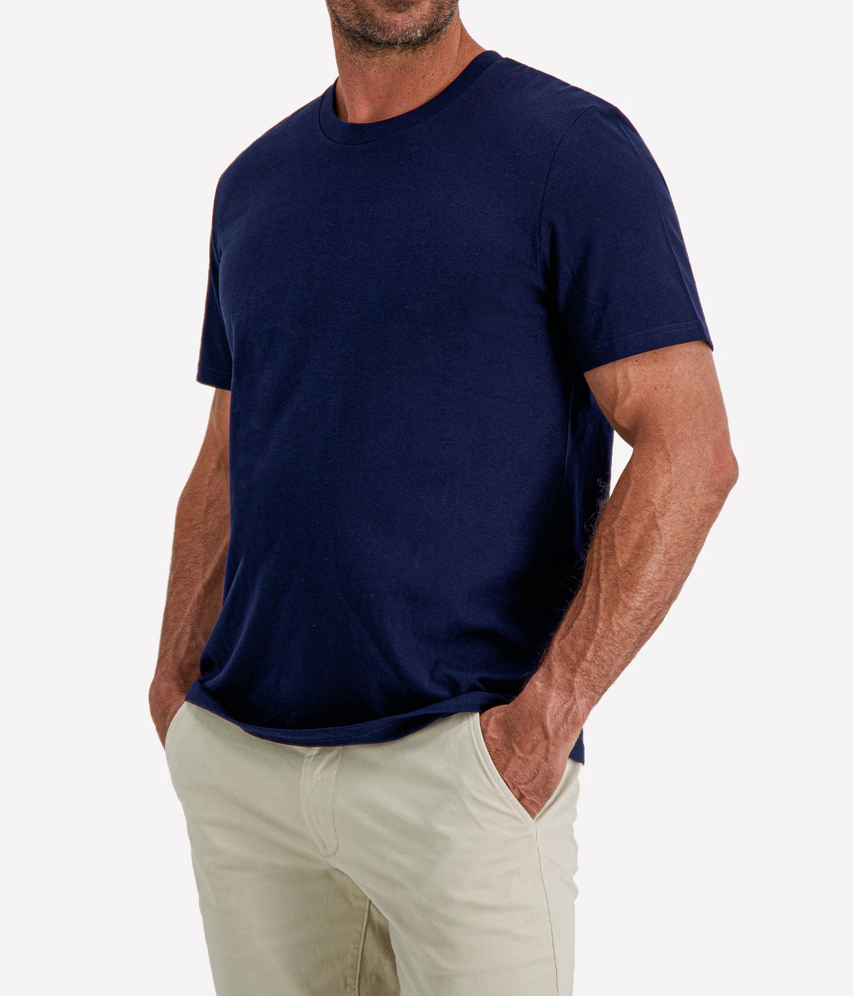 Man wearing Calexico Man Jamie Tee in Navy with stone shorts, cropped front view with hand in pocket