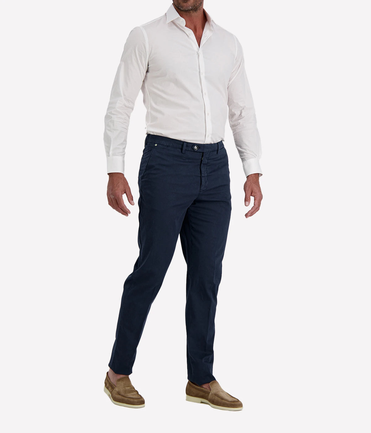 Man wearing Marco Pescarolo New York Cotton Silk Trouser in Navy with a white shirt and tan suede shoes, three-quarter view