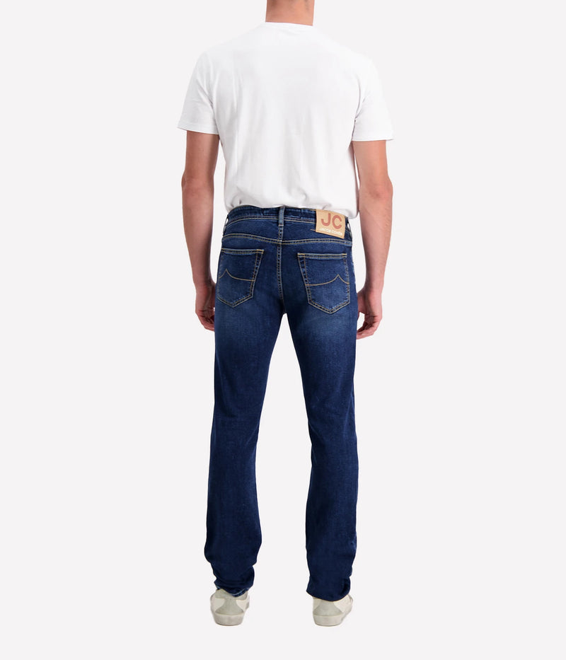 Bard 5-Pocket Jean by Jacob Cohen in a blue wash. Designed with a mid-rise, slim fit, and crafted from premium stretch denim, featuring signature branded hardware and a suede patch detail. A versatile, stylish jean suitable for both casual and formal looks.