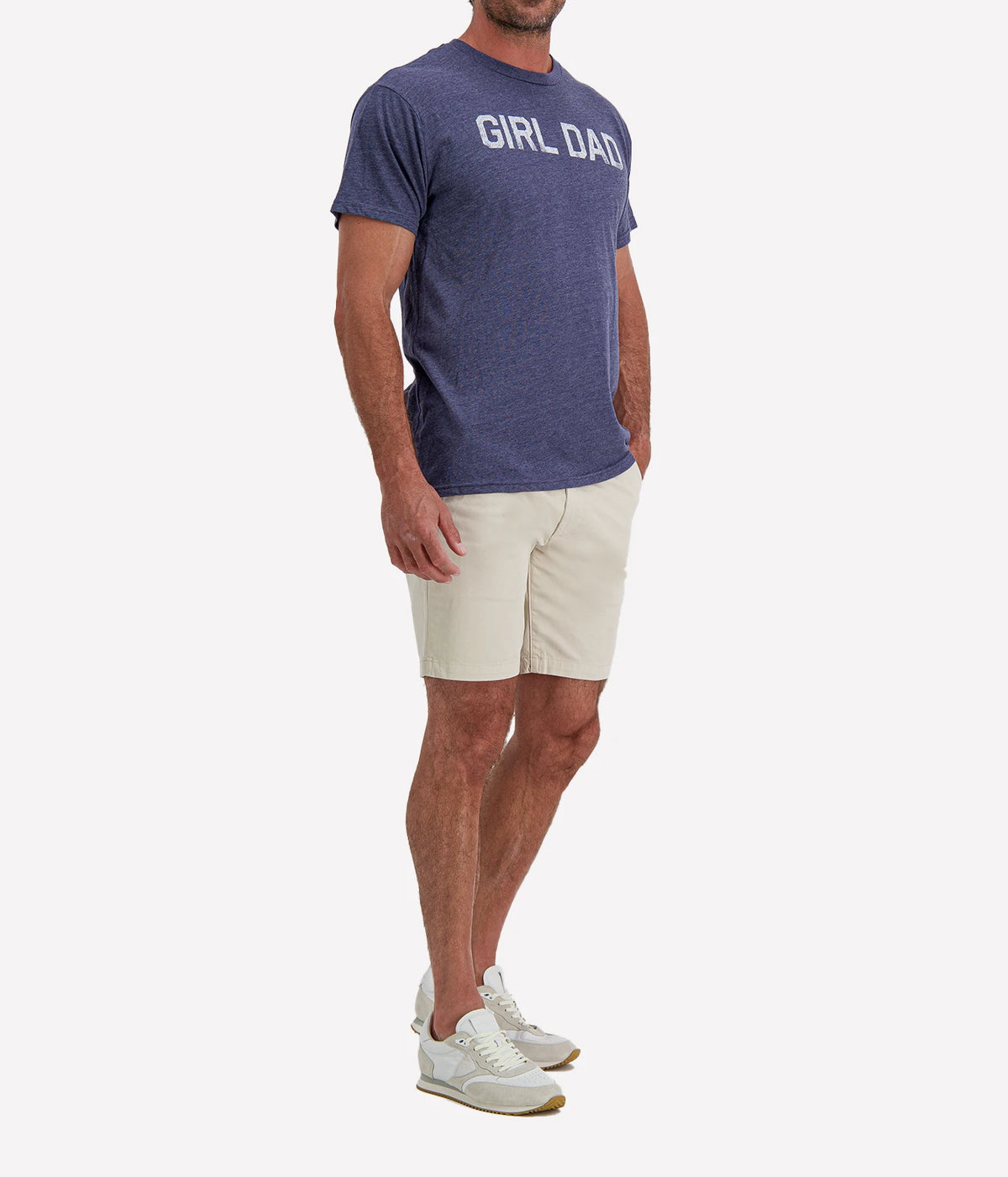 Man wearing Retro Brand Girl Dad Tee in Navy with stone shorts and white sneakers, three-quarter view