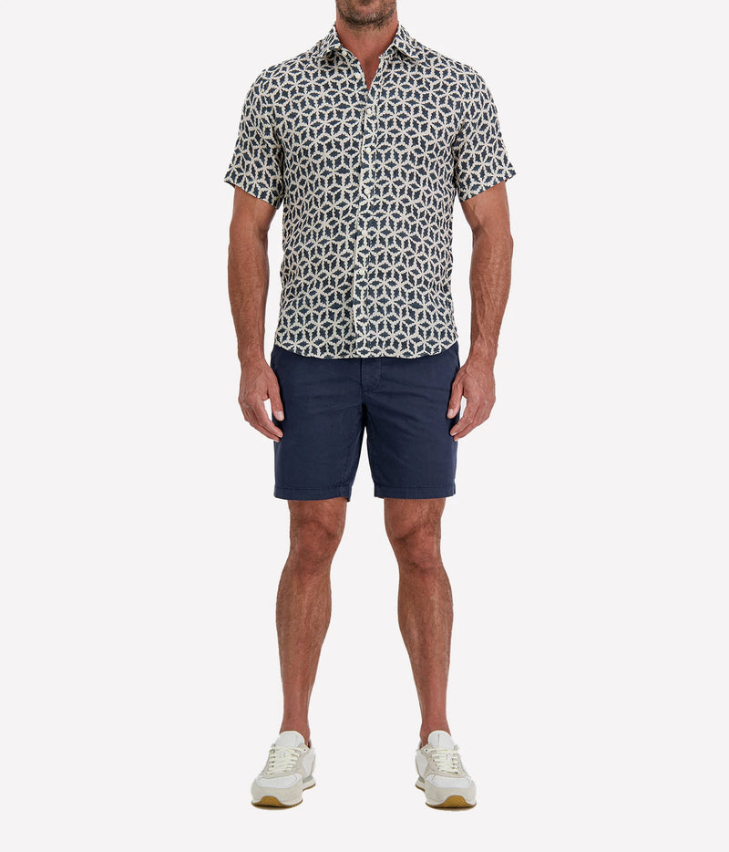 Man wearing Osvaldo Trucchi Linen Short Sleeve Shirt in Navy Geo Star Print with navy shorts and white sneakers, full-length front view