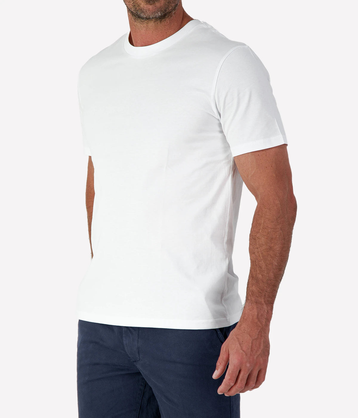 Man wearing Calexico Man Jamie Tee in White with navy shorts, cropped side view