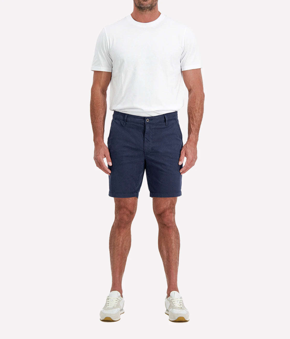 Man wearing AG Wanderer Short in Stormy Night with a white T-shirt and white sneakers, full-length front view