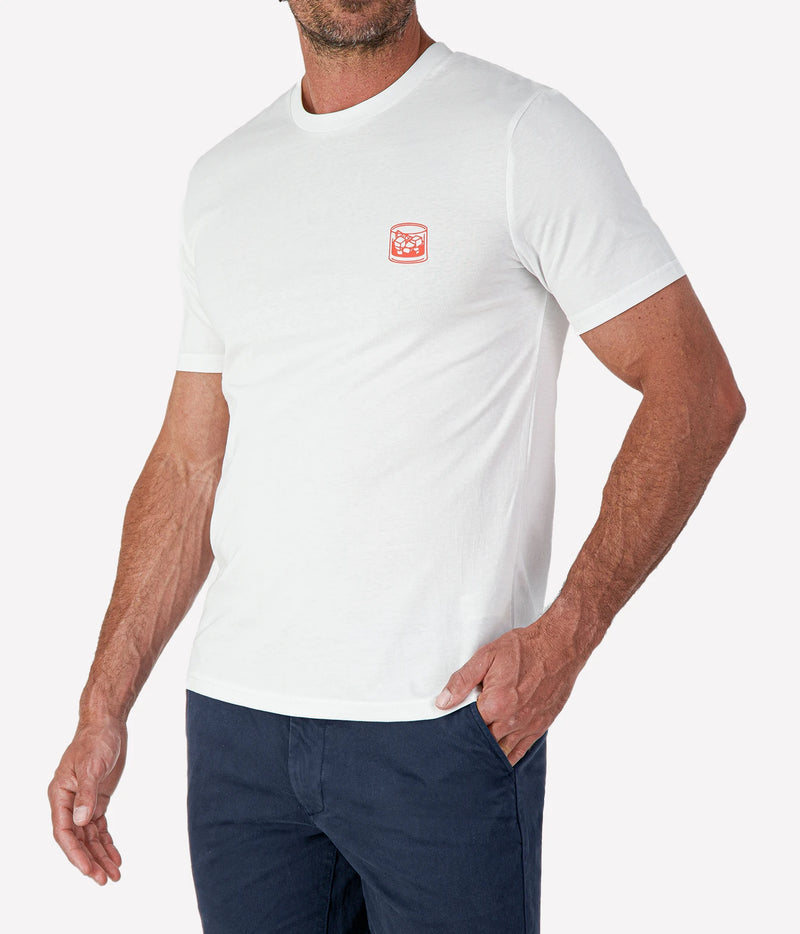 Man wearing The Refined Spirit Negroni Cocktail Bar Tee in White with navy shorts, cropped angled front view with hand in pocket