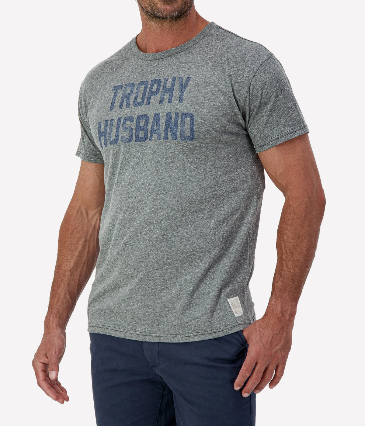 Man wearing Retro Brand Trophy Husband Tee in Grey & Navy with navy shorts, cropped angled front view