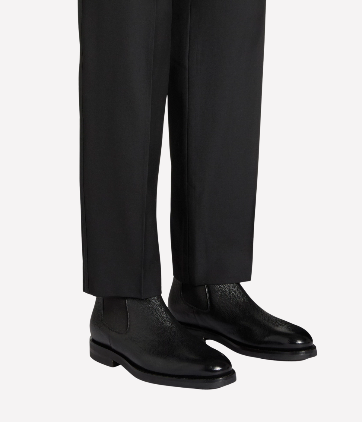 Men’s black leather Chelsea boots with elastic side panels, pull tab, and durable rubber sole by Santoni.