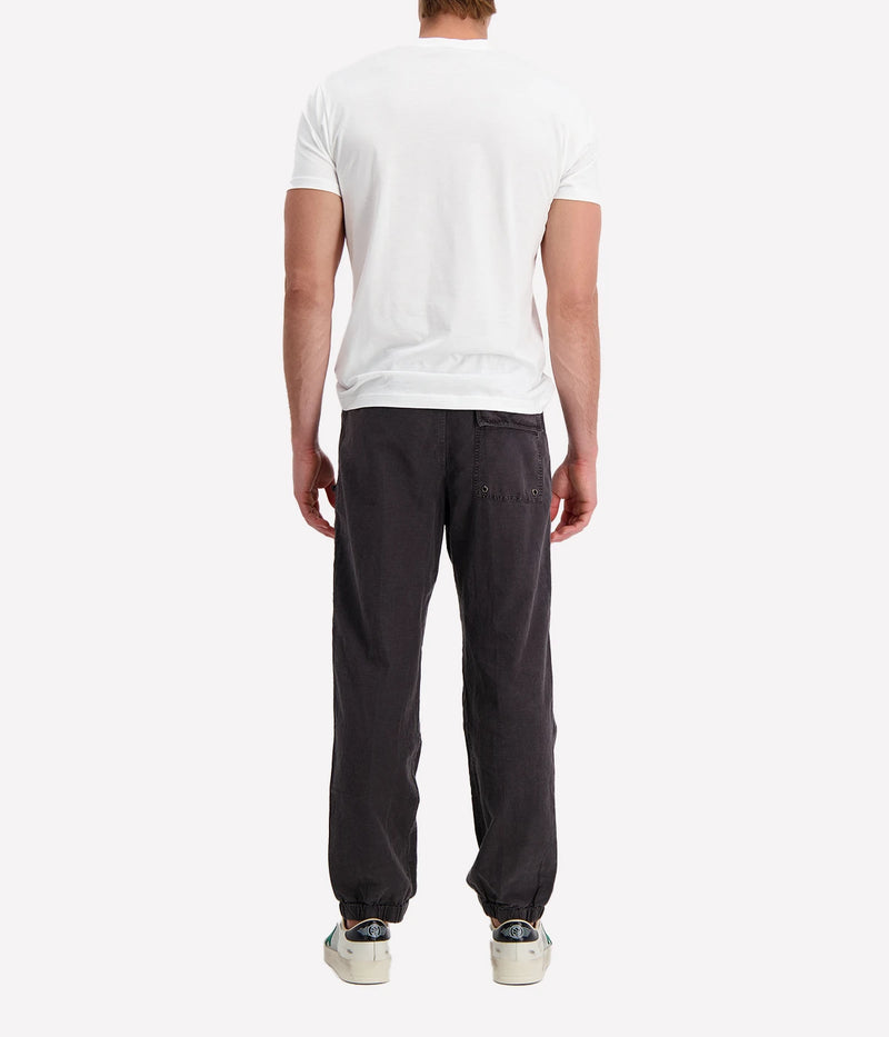 Textured cotton hemp flight pants in a relaxed fit, featuring a button fly, cuffed leg opening, knee tuck details, and snap button flap pockets. Crafted from breathable Italian cotton hemp with a unique textured finish.