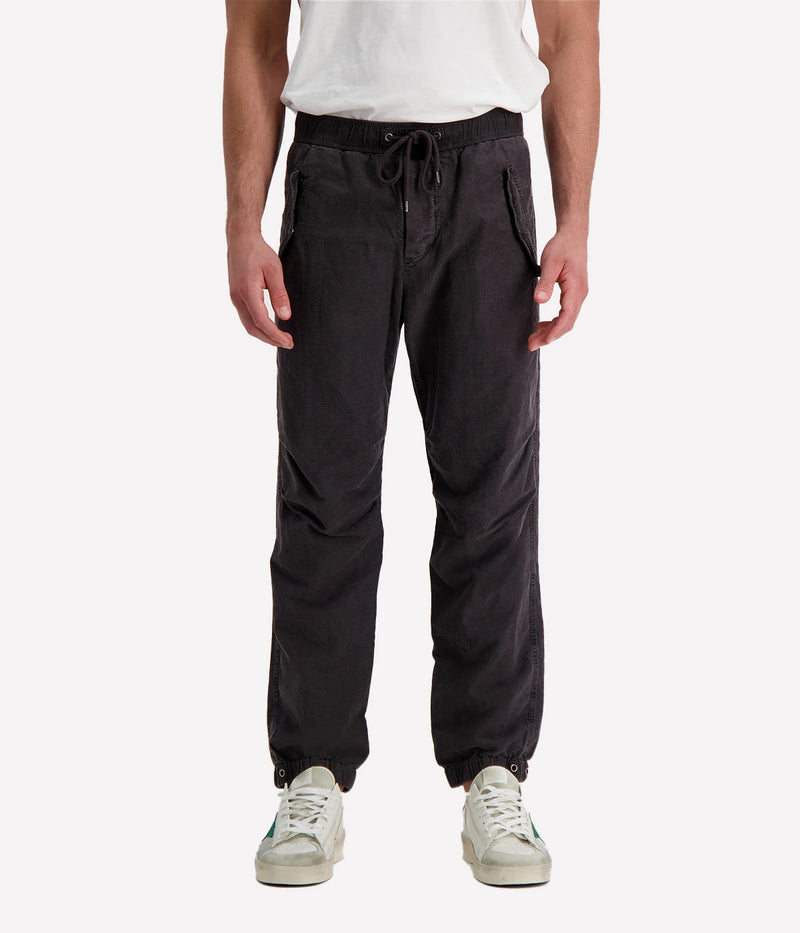Textured cotton hemp flight pants in a relaxed fit, featuring a button fly, cuffed leg opening, knee tuck details, and snap button flap pockets. Crafted from breathable Italian cotton hemp with a unique textured finish.