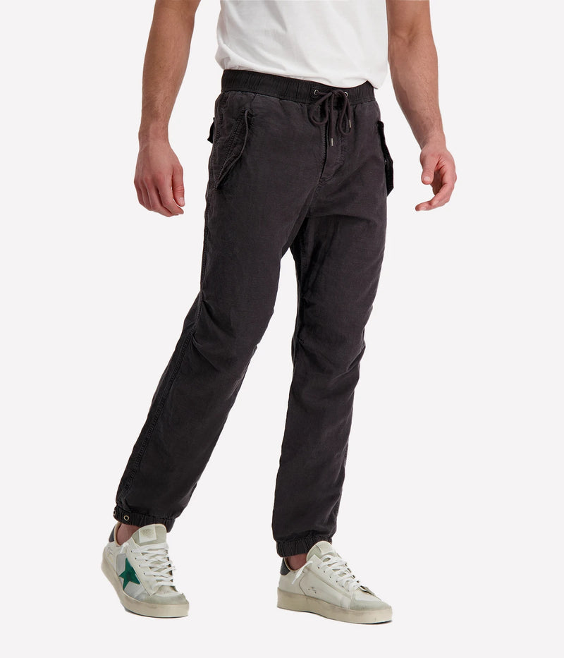 Textured cotton hemp flight pants in a relaxed fit, featuring a button fly, cuffed leg opening, knee tuck details, and snap button flap pockets. Crafted from breathable Italian cotton hemp with a unique textured finish.