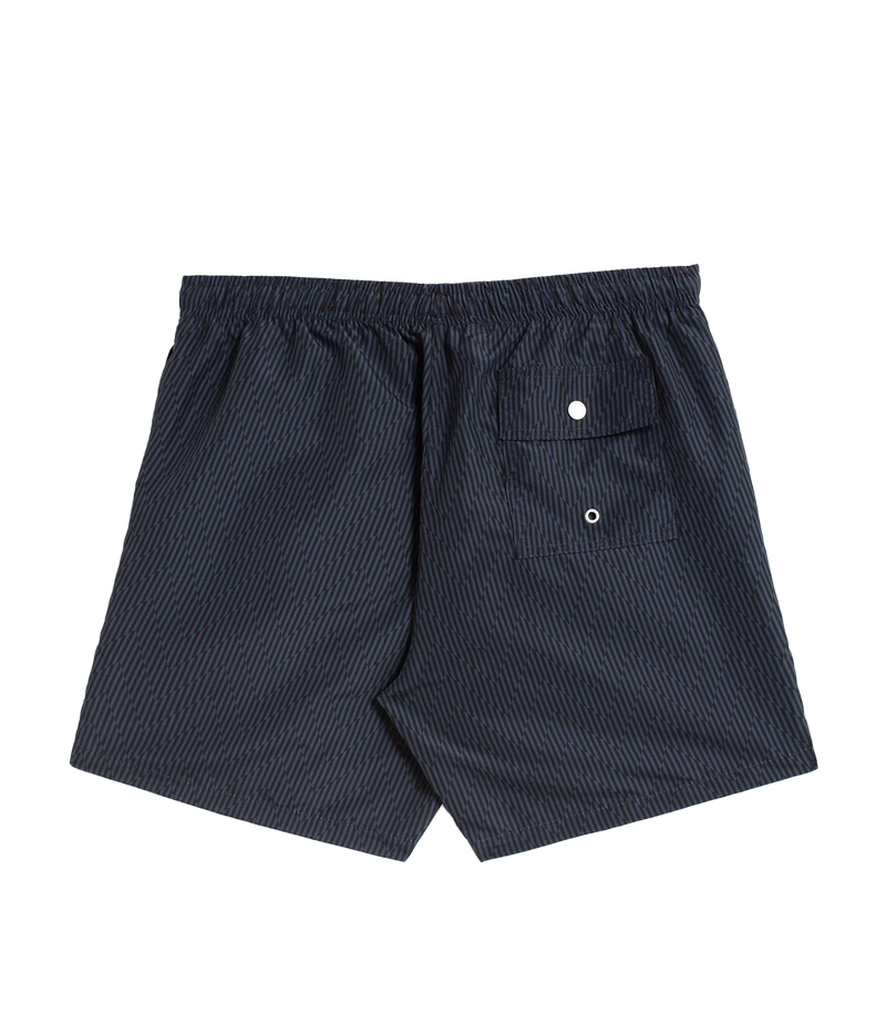 Bather’s geometric swim trunks feature a bold, monochromatic herringbone-inspired pattern, reminiscent of retro ‘60s design. With a 5.5” inseam, reinforced pockets, and a back snap pocket, these quick-dry swim shorts are crafted from 100% recycled polyester for a stylish and sustainable fit.