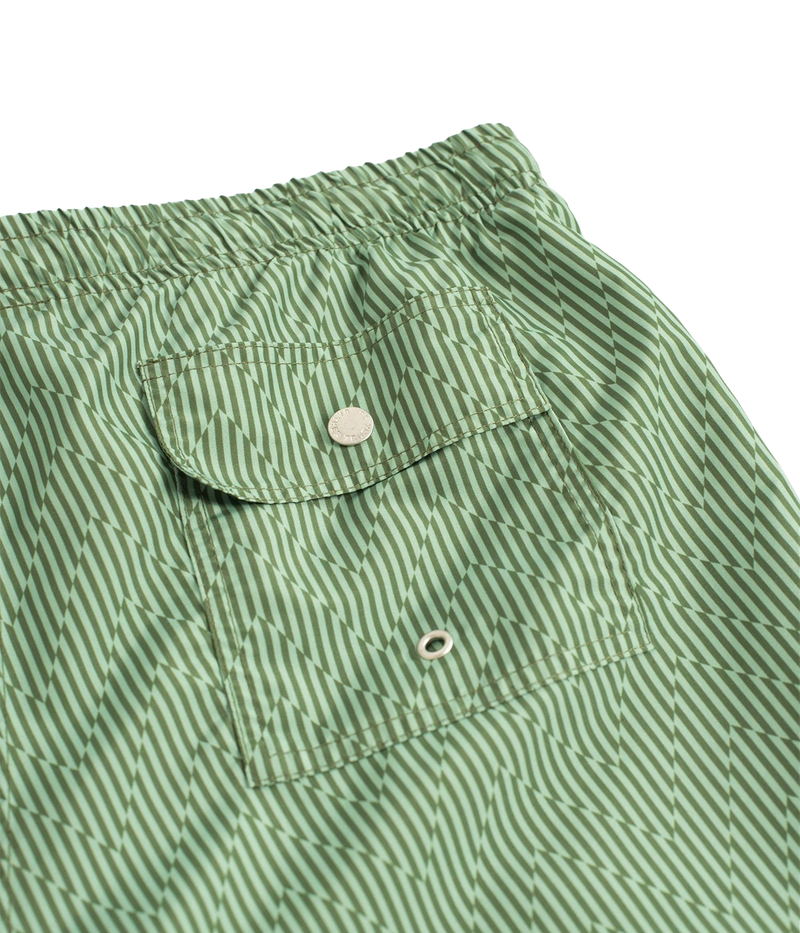 Bather’s geometric swim trunks feature a bold, monochromatic herringbone-inspired pattern, reminiscent of retro ‘60s design. With a 5.5” inseam, reinforced pockets, and a back snap pocket, these quick-dry swim shorts are crafted from 100% recycled polyester for a stylish and sustainable fit.