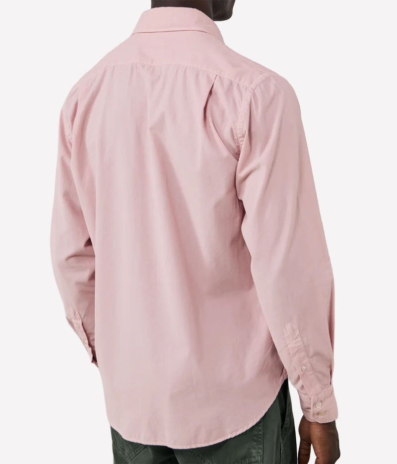 A man wearing a light pink long-sleeve button-down shirt, shown from the back against a plain light grey background.