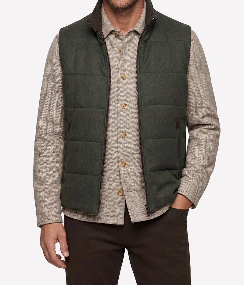 Model wearing Maurizio Baldassari Arena Quilted Wool Vest in Dark Olive over a beige shirt, front view