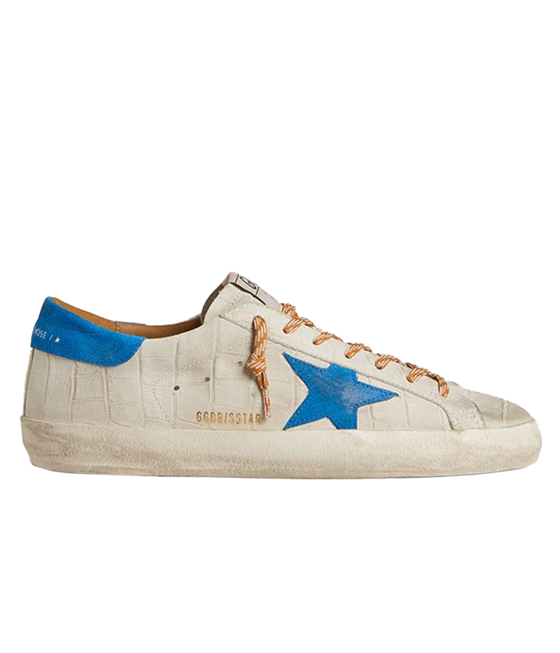 Golden Goose Superstar sneakers with white crocodile-embossed leather, blue suede star and heel tab, and distressed detailing. Made in Italy.